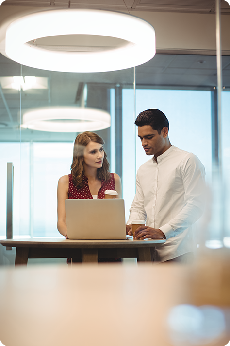 business people discussing over laptop in office